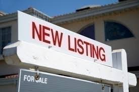 New listing sign in front of house.