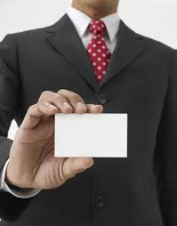 Person holding blank business card.