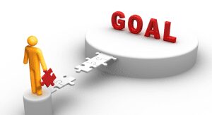 Person completing puzzle bridge to goal.