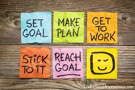 Sticky notes with motivational goal-setting phrases.
