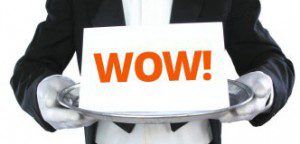 Butler holding a sign with "WOW!